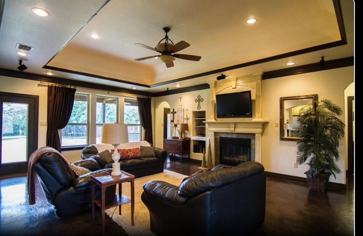 Living room with tray ceiling and fireplace